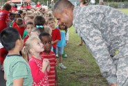 1st Lt. Roye Lockllear of the Florida National Guard's Drug Demand Reduction (DDR) team chats with schoolchildren during a Red Ribbon Week event in Florida in October. This year representatives from Counterdrug’s DDR conducted Red Ribbon Week presentations to more than a 126,000 schoolchildren throughout the state. Courtesy photo