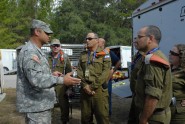 Lt. Col. Michael Ladd, commander of the Florida National Guard's 44th Weapons of Mass Destruction - Civil Support Team, briefs visitors from the Israeli Home Front Command and Israeli National Emergency Management Authority during a visit to Camp Blanding Joint Training Center, Nov. 15, as part of Shared Focus 2011.