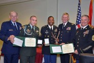 FLNG's NCO and Soldier of the Year!  Spc. Brian Crawley of the 53rd Brigade Combat Team (center) and Staff Sgt. Daniel Taylor from Joint Force Headquarters (second from left) are honored Saturday evening as the Soldier and the NCO of the Year by Florida National Guard leaders. Pictured with the Soldiers are: Adjutant General of Florida Maj. Gen. Emmett Titshaw Jr. (left), Assistant Adjutant General for Army Maj. Gen. James Tyre (second from right) and State Command Sgt. Maj. Robert Hosford. Photo by Debra Cox