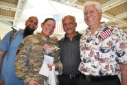 Florida Air National Guard members Staff Sgt. Brittany Kiselich poses with her fiance Jason Threatt (left), her grandfather Frank Klum Sr. (right) and her uncle Frank Klum Jr. during a welcome home ceremony for Kiselich's unit at the Jacksonville International Airport, April 10, 2012. Kiselich is part of the third-generation in her family to serve in military in a combat zone. Photo by Master Sgt. Thomas Kielbasa