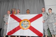 Florida Army National Guard Command Sgt. Maj. Robert Hosford (second from right) and Florida National Guard leaders present a Florida State Flag to members of the 2153rd Financial Management Detachment (FMD), on June 3, 2012. Hosford presented the flag so it could be flown with pride over the unit's headquarters during the 2153rd FMDâs deployment to Southwest Asia as a representation of the people of the state of Florida. Pictured are: Sgt. 1st Class Gerald Shugart, 2153rd Financial Management Detachment (FMD) NCO-IC, (left); Maj. Gen. James Tyre, Assistant Adjutant General for the Florida Army National Guard;  Capt. Enrique Martinez, Commander of the 2153rd FMD, Command Sgt. Maj. Robert M. Hosford, Florida Army National Guard Command Sergeant Major;  and Col. Valeria Gonzalez-Kerr, 50th Regional Support Group Commander. Photo by Spc. N. Bobby Ballard