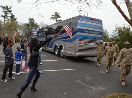 Families of Soldiers from the 869th Engineer Company rush to greet them as they unload from buses at their homecoming ceremony in Quincy, Fla., Jan. 8, 2013. Photo by Debra Cox