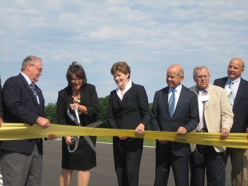 Mayor Lozeau cuts the ribbon as Senator Shaheen and Michael Huerta (to her right) look on