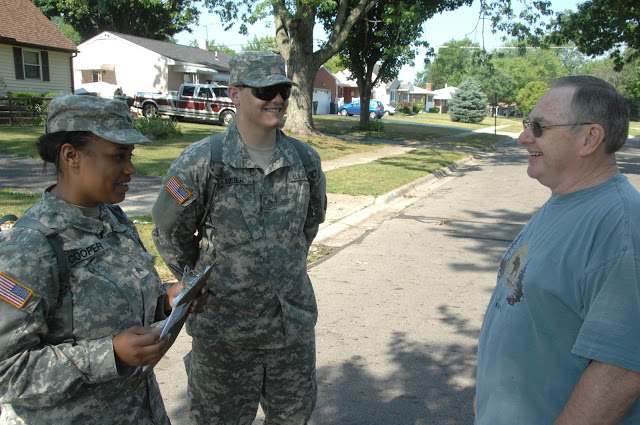 Sgt. Jessica Cooper (left) and Pvt. Jason Geier, of Headquarters and Headquarters Company, 216th Engineer Battalion, talk with John Weese, 60, of Columbus, Ohio, on July 2, 2012. (Ohio National Guard photo by Senior Airman Jordyn Sadowski)
