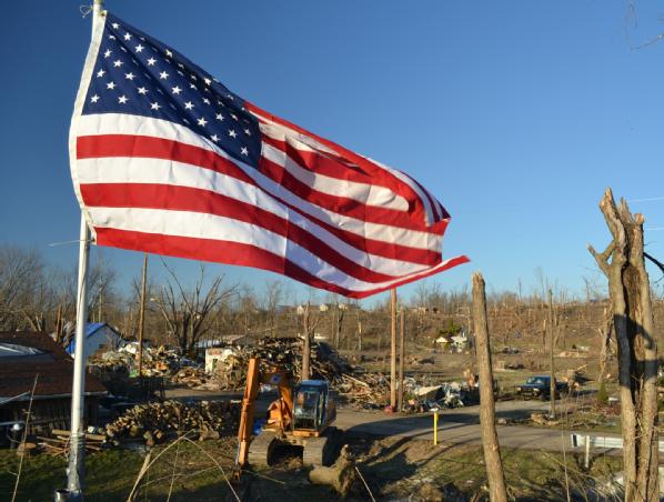 Henryville, Ind., March 8, 2012 -- The American Flag waves as a symbol of hope over the damaged homes and striped hillside after two tornadoes torn through the community of 1,900 residents in Southern Indiana on March 2. President Obama issued a major disaster declaration on March 9, two days after the Joint Preliminary Damage Assessments were completed in six counties.