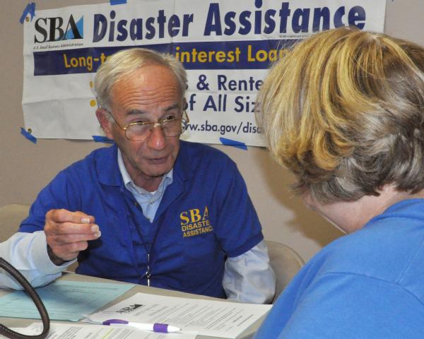Frenchburg, Ky., March 12, 2012 -- Michael Caulkins, Small Business Association Specialist, discusses with an applicant the SBA loan process. FEMA partners with the Small Business Association, which provides low interest loans to disaster survivors.