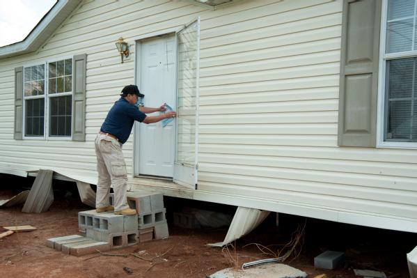 McMinn County, Tenn., March 20, 2012 -- Michael Gann, Community Relations Specialists, leaves a registration information flyer at a damaged residence. FEMA and State representatives are on the ground giving information about registration and disaster assistance to residents.