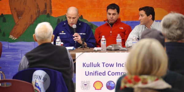 Capt. Jerald Woloszynski, commanding officer Coast Guard Base Kodiak, addresses comments about the Kulluk Tow Incident to assembled members of the Kodiak community at the Kodiak High School commons in Kodiak, Alaska, Wednesday, Jan. 9, 2013. The unified command was in Kodiak to address questions and concerns from residents. U.S. Coast Guard Photo by Petty Officer 1st Class Sara Francis.