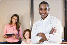 African American office worker with female colleagues, focus on man