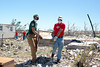 Megan Helton, an AmeriCorps member with the Texas American Youthworks Enviromental Corps Assists a Kansas City Chief player move debris. (Photo by Scott Julian, 2011)