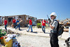 An AmeriCorps NCCC member directs Kansas City Chief players at a volunteer site in Joplin, MO. (Photo by Scott Julian, 2011).
