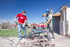Mark Wilson, part of the Iowa Conservation Corps, works with a Kansas City Chiefs player to clean up debris in Joplin, MO. (Photo by Scott Julian, 2011)
