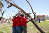Mark Wilson, an AmeriCorps member with the Iowa Conservation Corps, assists Kansas City Chiefs players with the removal of tree debris in Joplin, MO. (Photo by Scott Julian, 2011)
