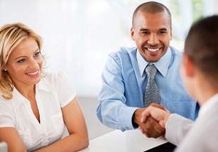 Image of men shaking hands and woman smiling.