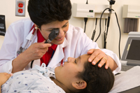 Doctor examining a young girl's eyes