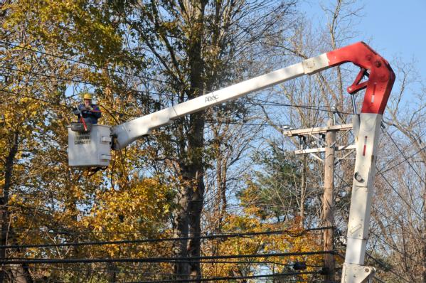 Utility crews work to restore power in the aftermath of a deadly winter storm.
