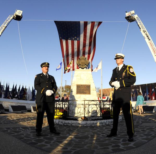 Firefighters stand at the National Fallen Firefighters Memorial during the Fallen Firefighters memorial service.