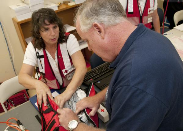 Kevin L. Hannes, FEMA Federal Coordinating Officer, inspects an emergency relief kit.