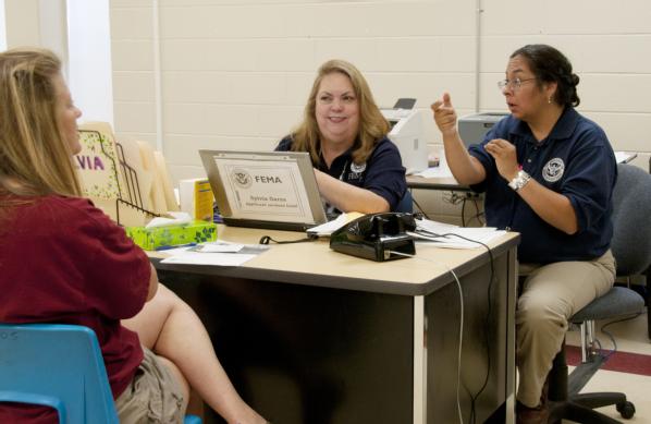 FEMA Community Relations and Individual Assistance specialists work with deaf and hard of hearing survivors at a Disaster Recovery Center