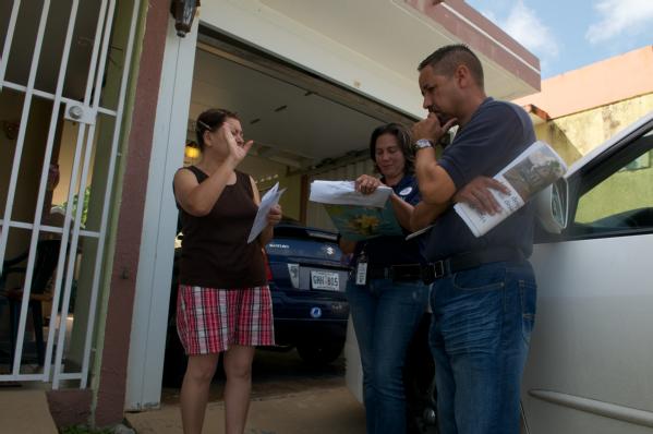 FEMA community relations specialists review damaged properties.