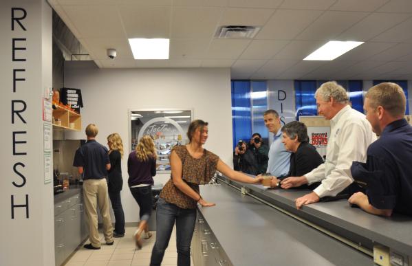 Education Secretary Arne Duncan (end of counter), Homeland Security Secretary Janet Napolitano (middle) and FEMA Deputy Administrator Richard Serino (right) purchase a drink at the Joplin High School coffee shop.