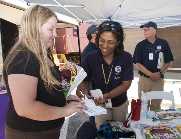 A FEMA Community Relations specialist speaks with a resident during an community event in Rogers, AR.