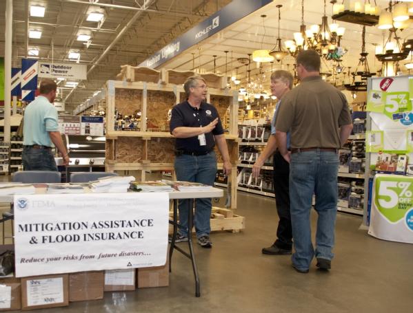 A FEMA Mitigation specialist talks to a residents about what needs to be done to protect his home against flooding or potential high winds and tornadoes.