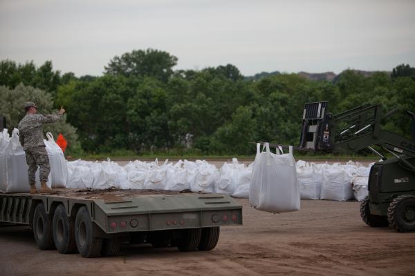 National Guard load 1,000 lb. sandbags onto a flatbed truck to use on levees along the Souris River in Minot. FEMA is providing disaster assistance to Ward and Burleigh counties.