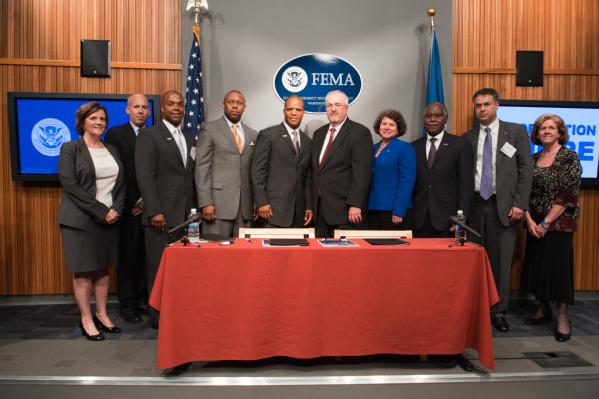Board members from Operation HOPE and senior leadership from FEMA pose for a group picture after the signing of a memorandum of agreement (MOA) between the two organizations.