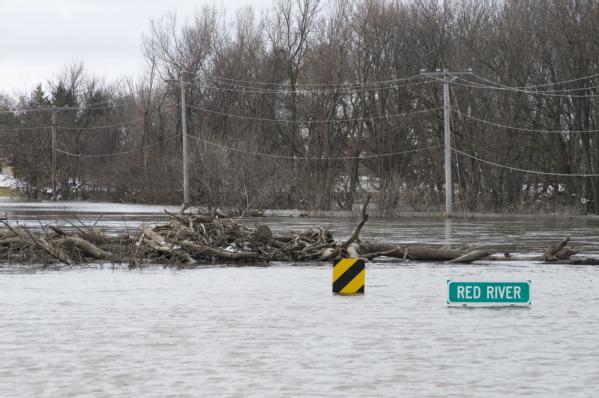 The Red River drowns the roadway and completely covers over a bridge just north of Moorhead, MN.