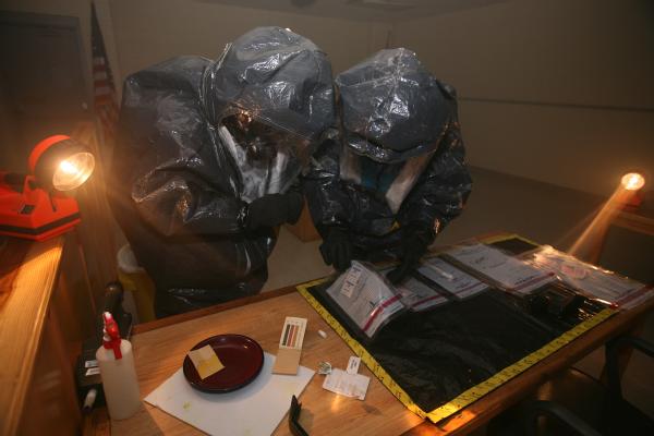 First Responders collect evidence from a potential hazardous crime scene, during a training exercise at the Center for Domestic Preparedness