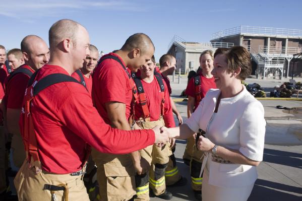 Elizabeth Harman greets members of Phoenix Fire Department recruit class 11-1 during a break from live fire training on January 19, 2011. The class of 28 firefighters is funded by a Staffing for Adequate Fire and Emergency Response grant.