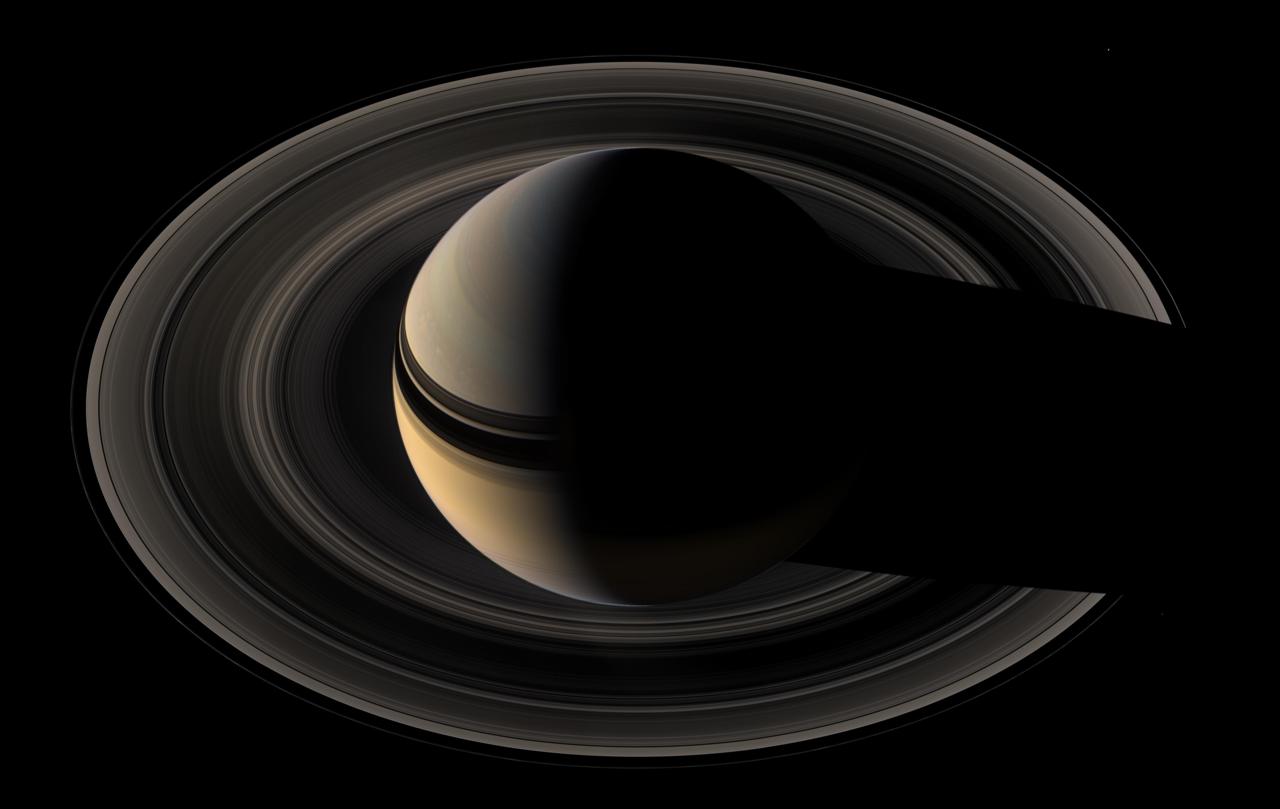 Image description: Saturn and its rings cast striking shadows on each other in this mosaic of images captured by NASA&#8217;s Cassini spacecraft. The view combines 45 images taken over the course of about two hours, as Cassini scanned across the entire main ring system from a distance of about 1.1 million kilometers (700,000 miles).
Image by NASA/JPL/Space Science Institute