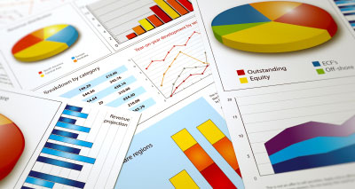 pie charts, bar graphs, and other charts scattered on a table