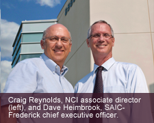 Standing in front of the visitors’ entrance at the Advanced
Technology Research Facility are Craig Reynolds,
NCI associate director (left), and Dave Heimbrook,
SAIC-Frederick chief executive officer.
