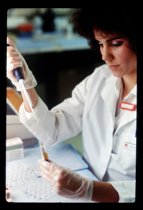 Scientist using pipet with test tube and blood