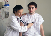 Photo of a doctor with a stethoscope examining a patient