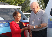Emma Metcalf accepts keys to 2 new vans from Bob Barrett