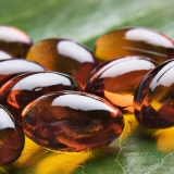 Fish oil capsules on a leaf