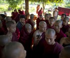 Buddhist monks, some of who escape from the security forces crack down, listen to radio news cast from a monastery in Monywa, northwestern Myanmar, Thursday, Nov. 29, 2012 (AP)
