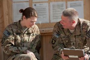 Female service member talking with male service member