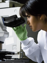 Female Scientist at Microscope
