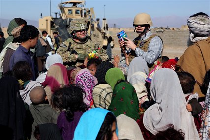 U.S. Army Lt. Col. Mark Martin, left, and Ray Sudweeks, right, U.S. State Department representative, pass out toys and school supplies to Afghan children in a village in Farah province, Afghanistan, Feb. 9, 2013. Martin, a civil affairs officer, is assigned to Provincial Reconstruction Team Farah.