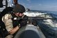 U.S. Navy Petty Officer 2nd Class James Doerner assumes a ready-to-fire position aboard a rigid-hull inflatable boat during a visit, board, search and seizure exercise in the U.S. 5th Fleet area of responsibility, Feb. 11, 2013.  U.S. Navy photo by Petty Officer 2nd Class Armando Gonzales