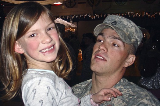 Then-Army Staff Sgt. Clinton L. Romesha greets his oldest child, Dessi, during his homecoming from Iraq. Romesha Family courtesy photo