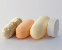 Four generic supplement pills: fiber, multivitamin, fish oil, and garlic.