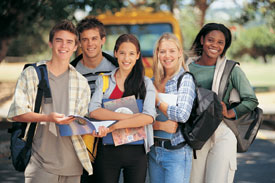 group of students with school bus in background