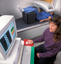 Photo of a patient and technician with DXA machine