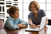 Photo of woman and boy using a laptop