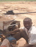 A Nigerian man with an ore crusher